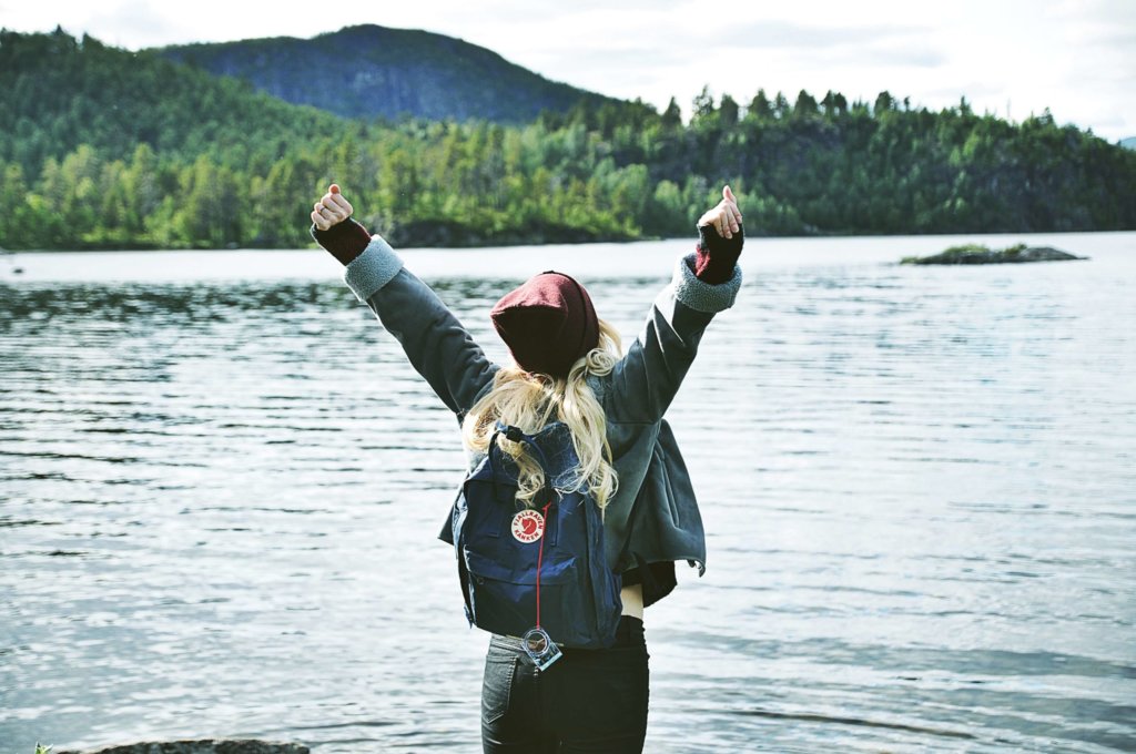 A backpacker in front of a Scandinavian lake