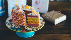 bright cake on stand with presents