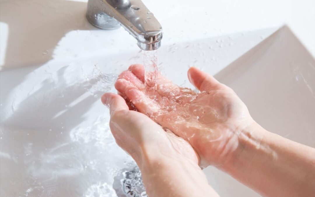 Woman washes her hands and uses too much water