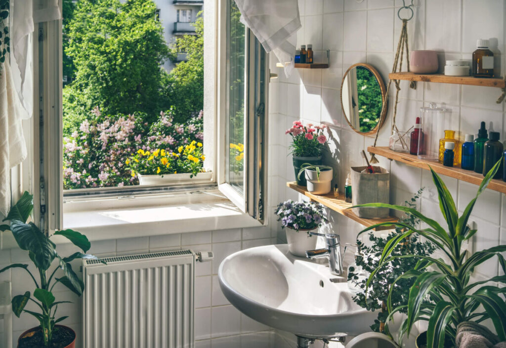 Bright bathroom with multiple plants.