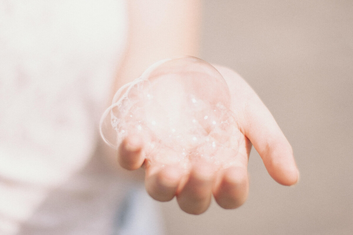 An image of a person holding a bubble from their homemade bubble bath
