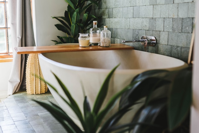 An image of plants used as decor around a bathtub