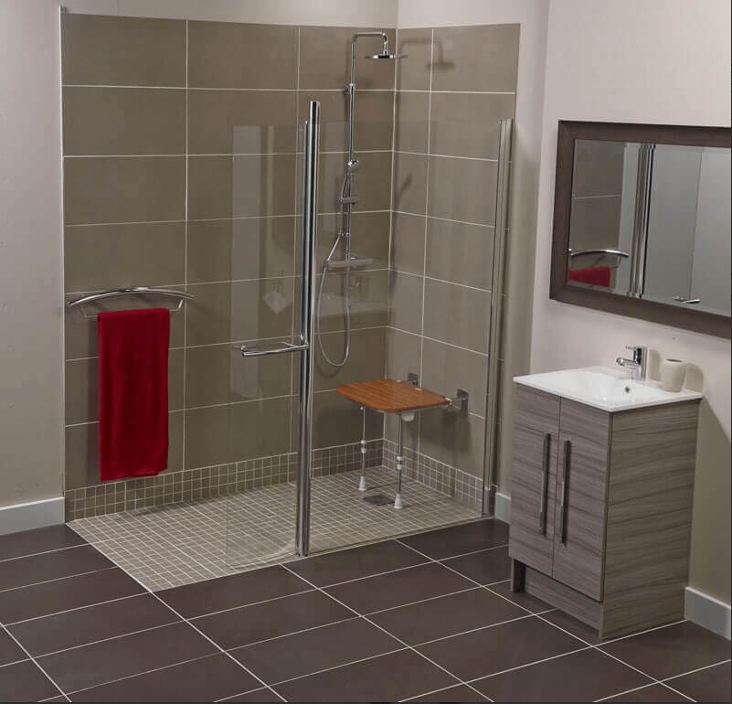 A spacious, tiled wet room with a rainfall showerhead and minimal threshold.